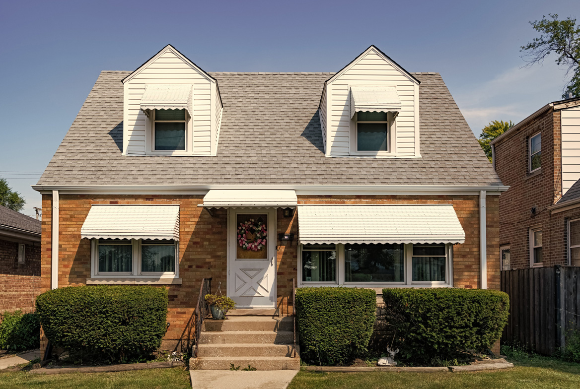 Row of postwar Cape Cod houses on a Long Island street